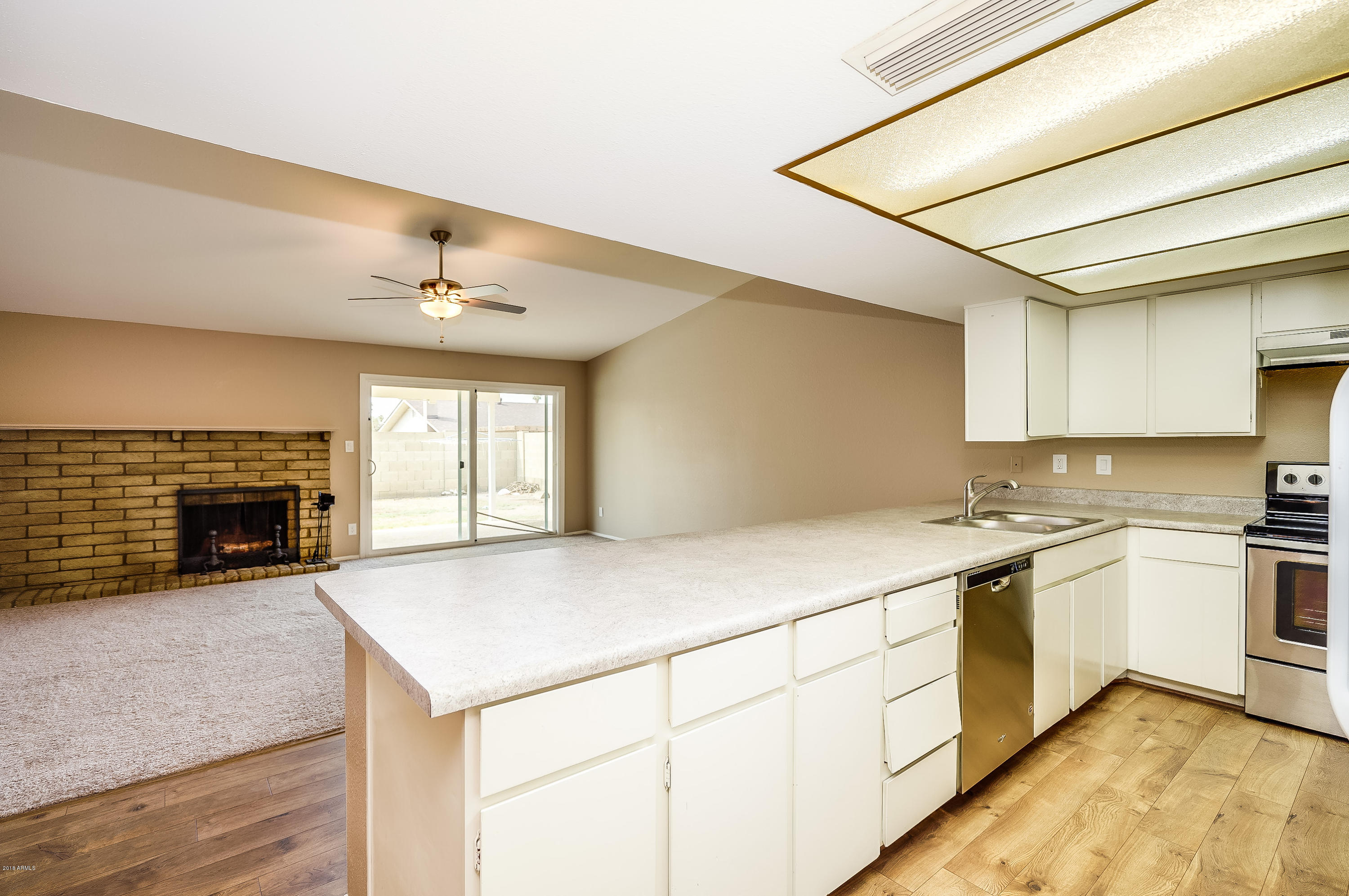 6509 West Camelback Road Phoenix, AZ 85033 - Photo 8 of 25 a kitchen with a stove and a sink