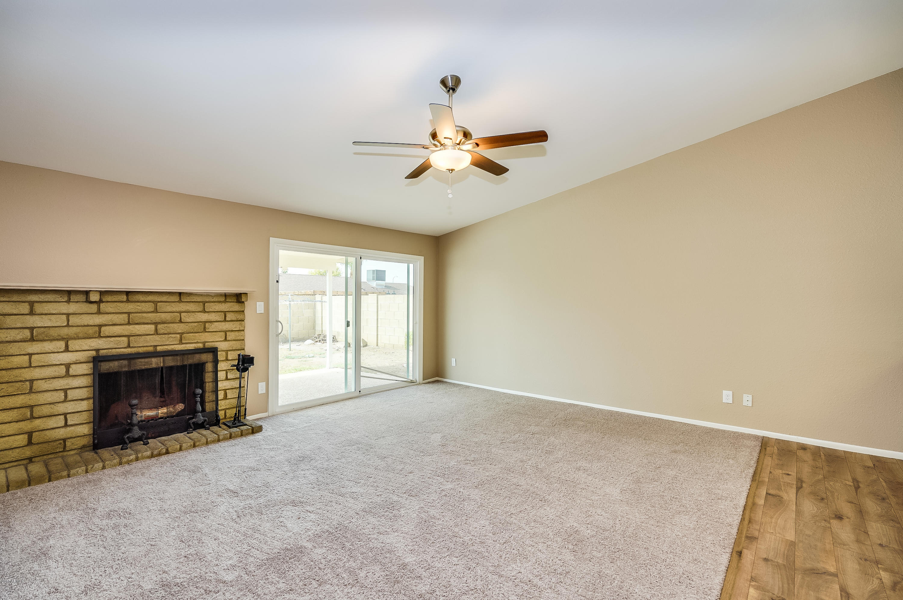 6509 West Camelback Road Phoenix, AZ 85033 - Photo 10 of 25 a view of empty room with fireplace and fan
