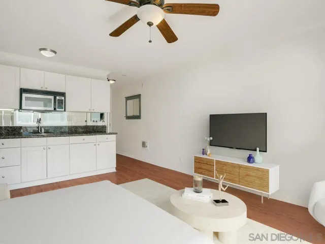 a spacious bedroom with a workspace