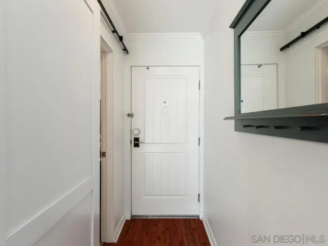 a view of walk in closet with wooden floor