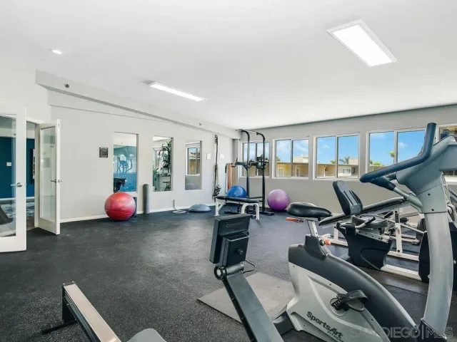 a living room with furniture and gym equipment