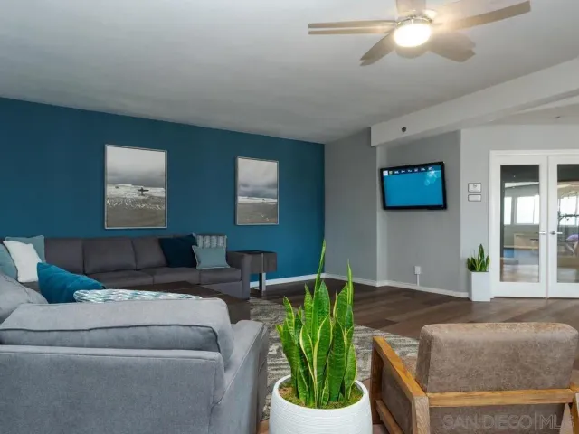 a living room with furniture and a potted plant