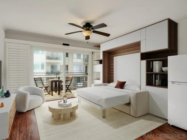 a bedroom with furniture and a large window