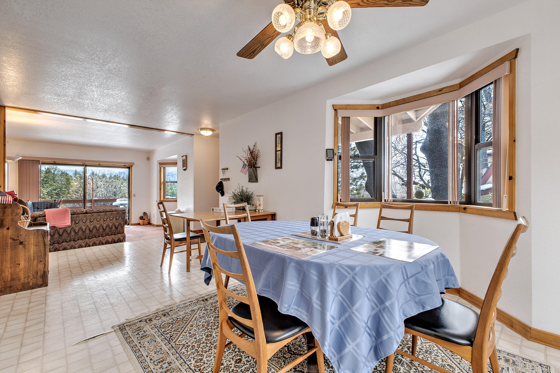 25006 Knob-Hill Idyllwild, CA 92549 - Photo 20 of 47 a view of a dining room with furniture large windows and wooden floor