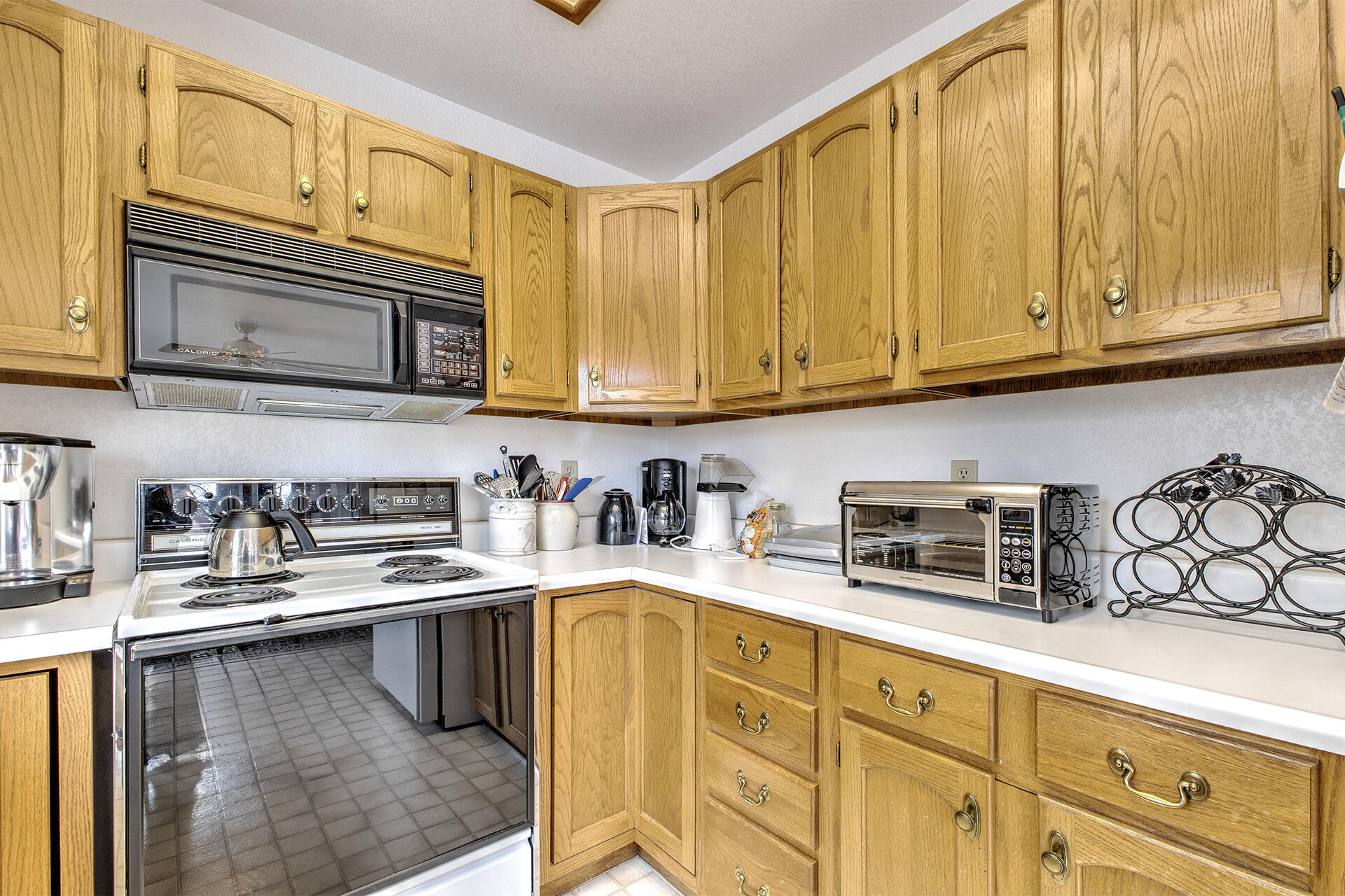 25006 Knob-Hill Idyllwild, CA 92549 - Photo 25 of 47 a kitchen with granite countertop cabinets stainless steel appliances a sink and wooden cabinets