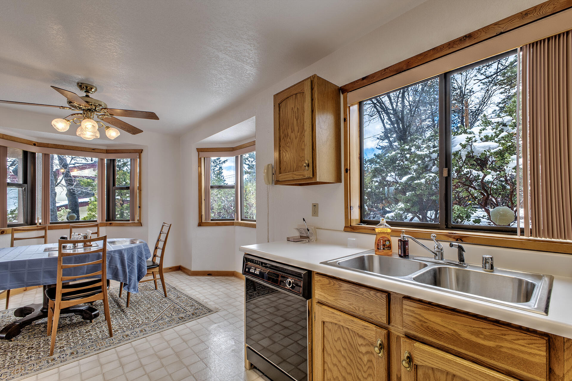 25006 Knob-Hill Idyllwild, CA 92549 - Photo 27 of 47 a kitchen that has a sink and chairs in it