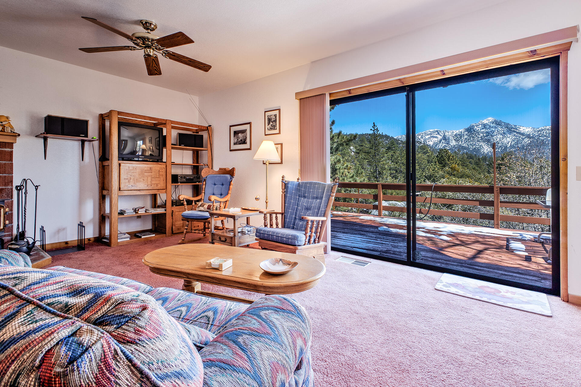 25006 Knob-Hill Idyllwild, CA 92549 - Photo 8 of 47 a living room with couch a fireplace and a flat screen tv