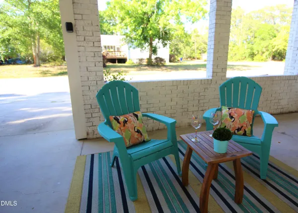 a view of two chairs in the patio