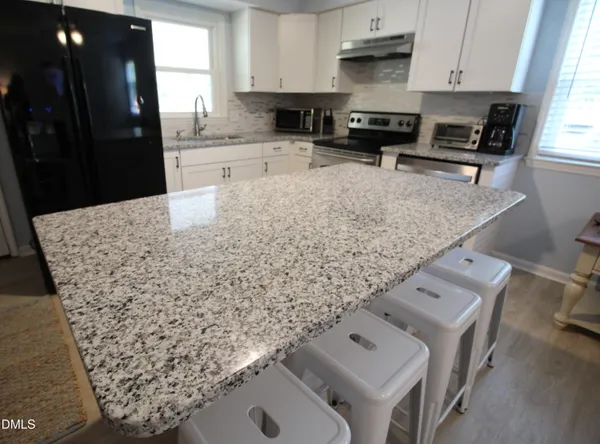 a kitchen with a stove and a refrigerator