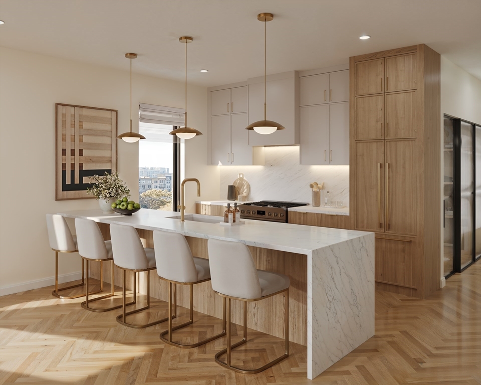 a kitchen with stainless steel appliances kitchen island granite countertop a table chairs stove and white cabinets