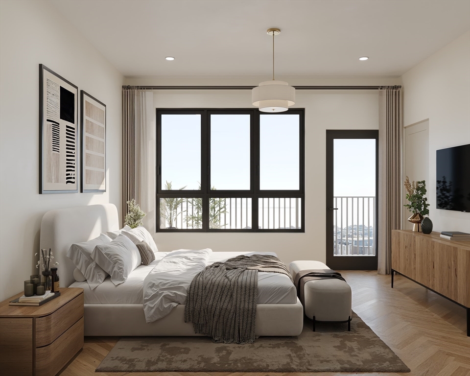 545 East 2nd Street, Unit 3 Boston, MA 02127 - Photo 5 of 9 a bedroom with a bed couches and a flat tv screen