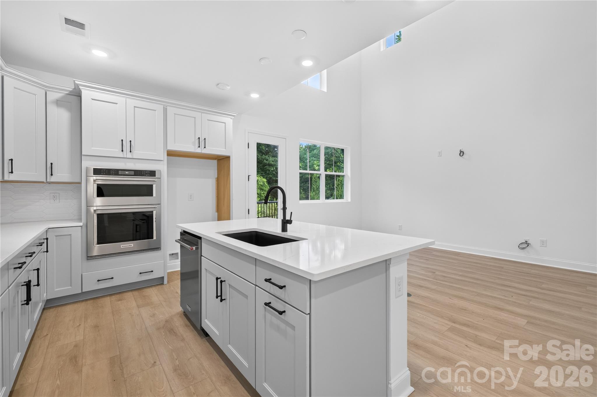 416 Celestial Drive Tega Cay, SC 29708 - Photo 4 of 21 a kitchen with granite countertop a sink stove and refrigerator