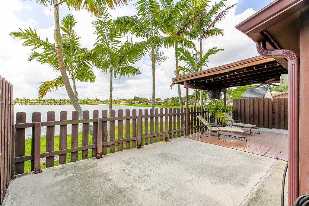 a view of outdoor space with deck and palm trees