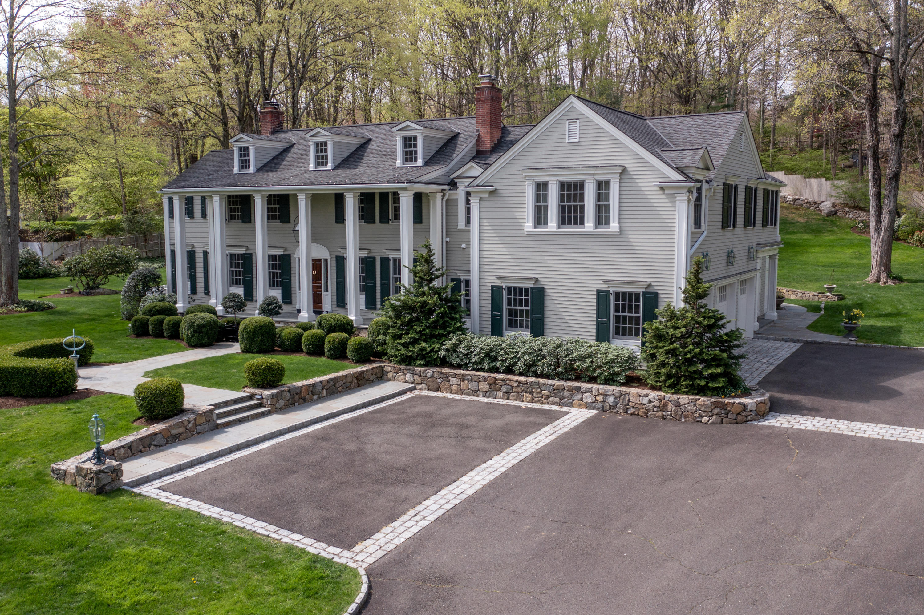 a front view of a house with a yard and porch