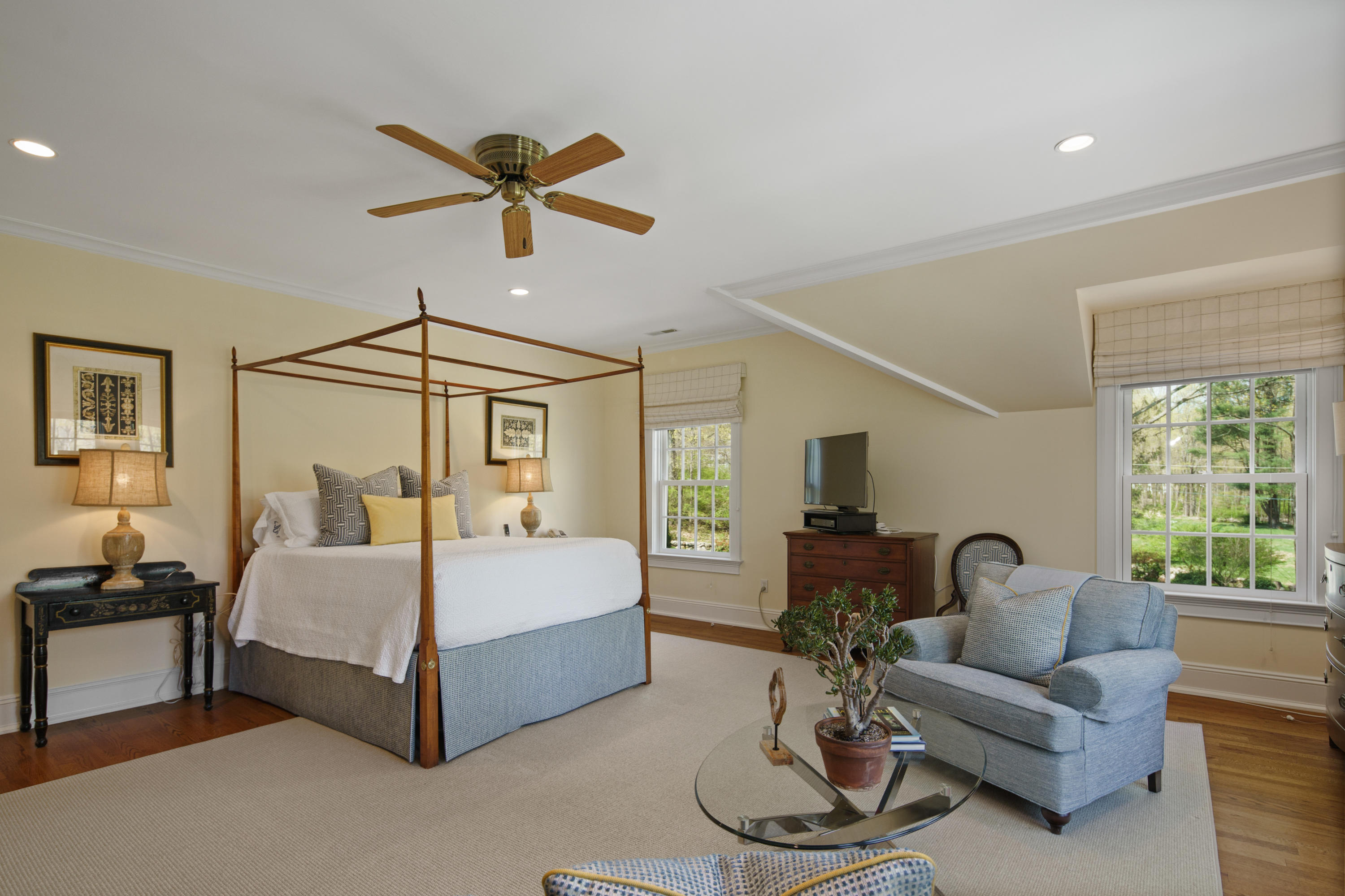 398 Valley Road New Canaan, CT 06840 - Photo 20 of 44 a spacious bedroom with a bed couch and a window
