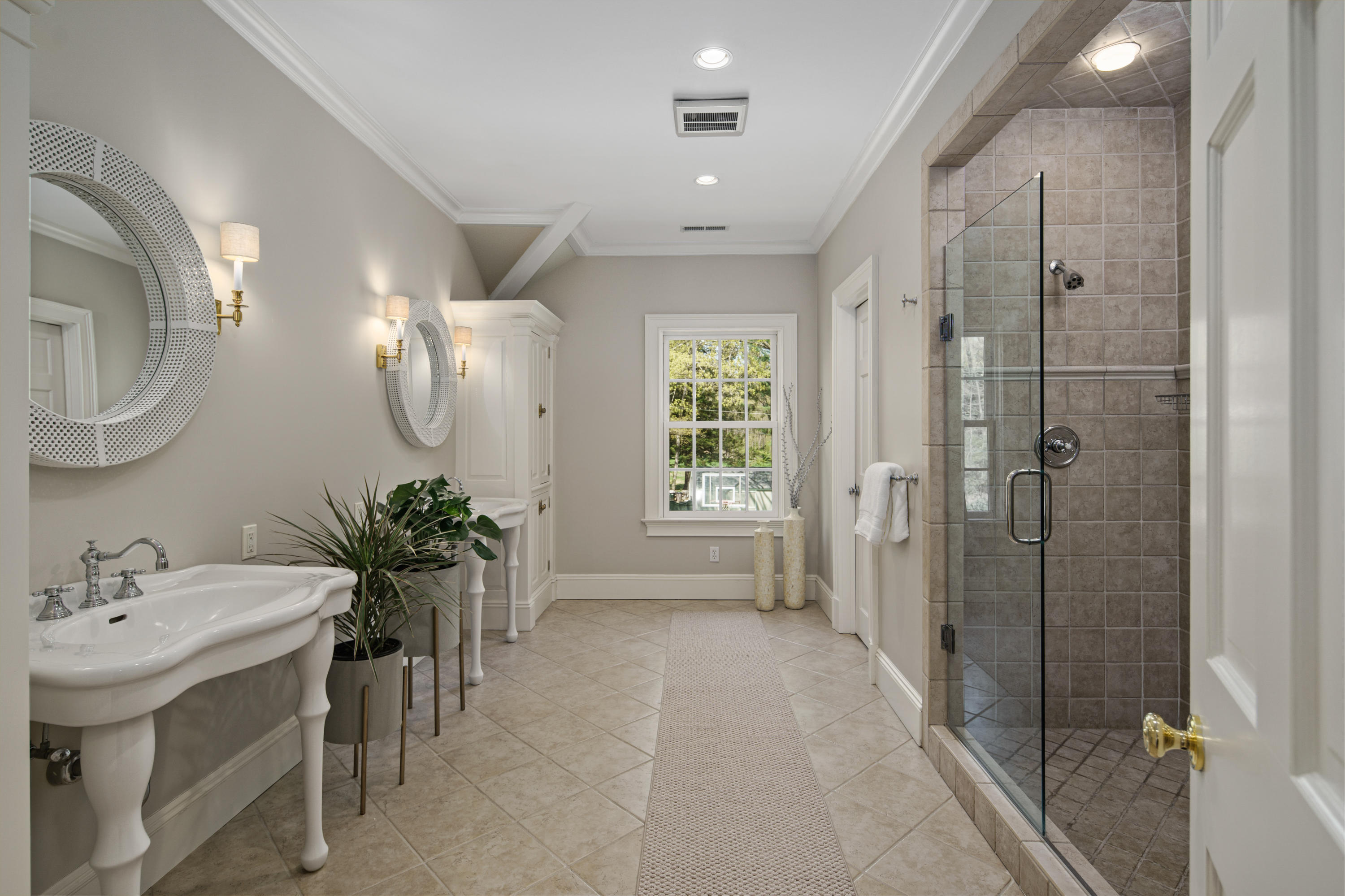 398 Valley Road New Canaan, CT 06840 - Photo 21 of 44 a spacious bathroom with a shower sink and mirror