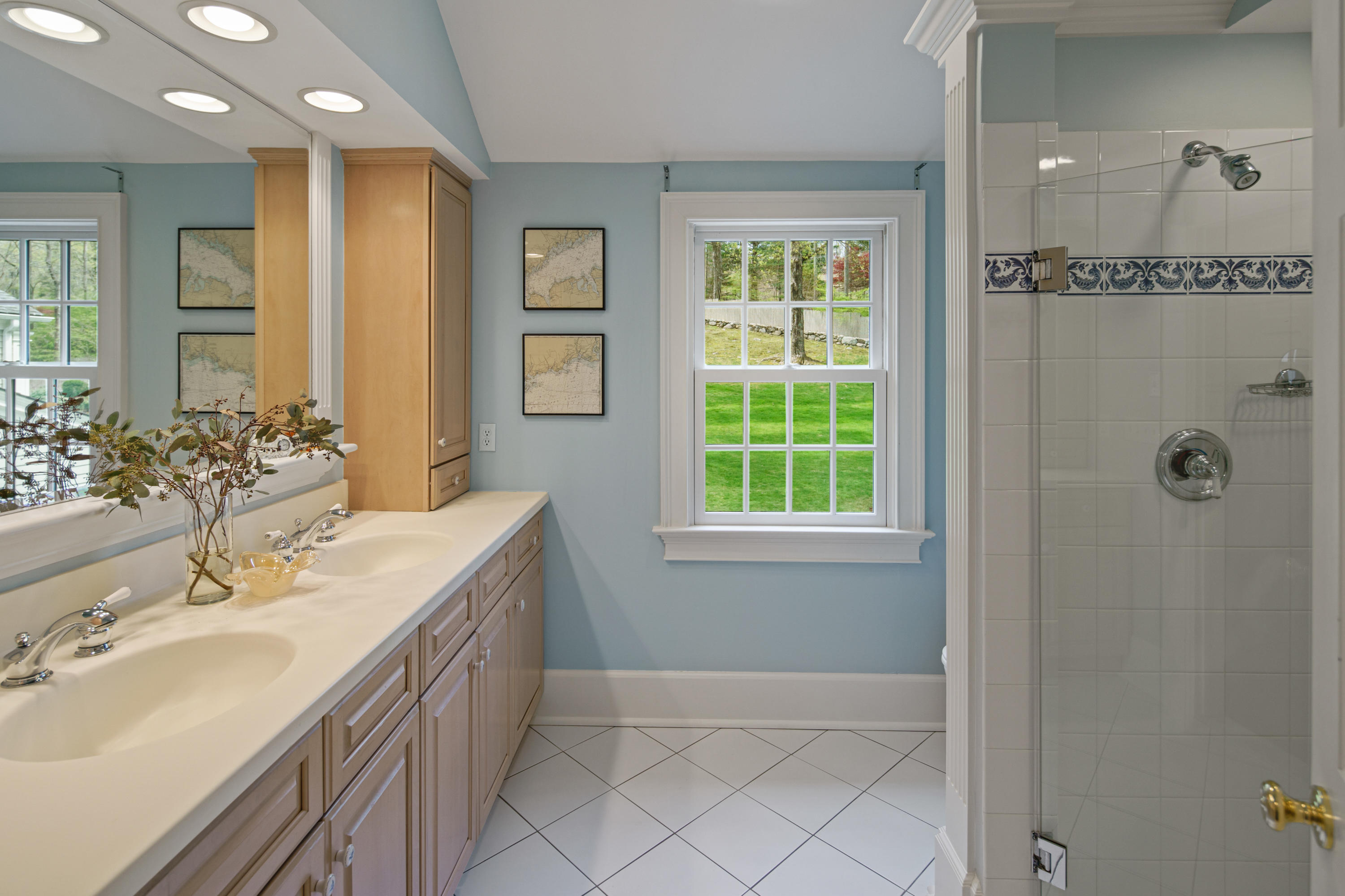 398 Valley Road New Canaan, CT 06840 - Photo 24 of 44 a spacious bathroom with a double vanity sink a mirror and a shower