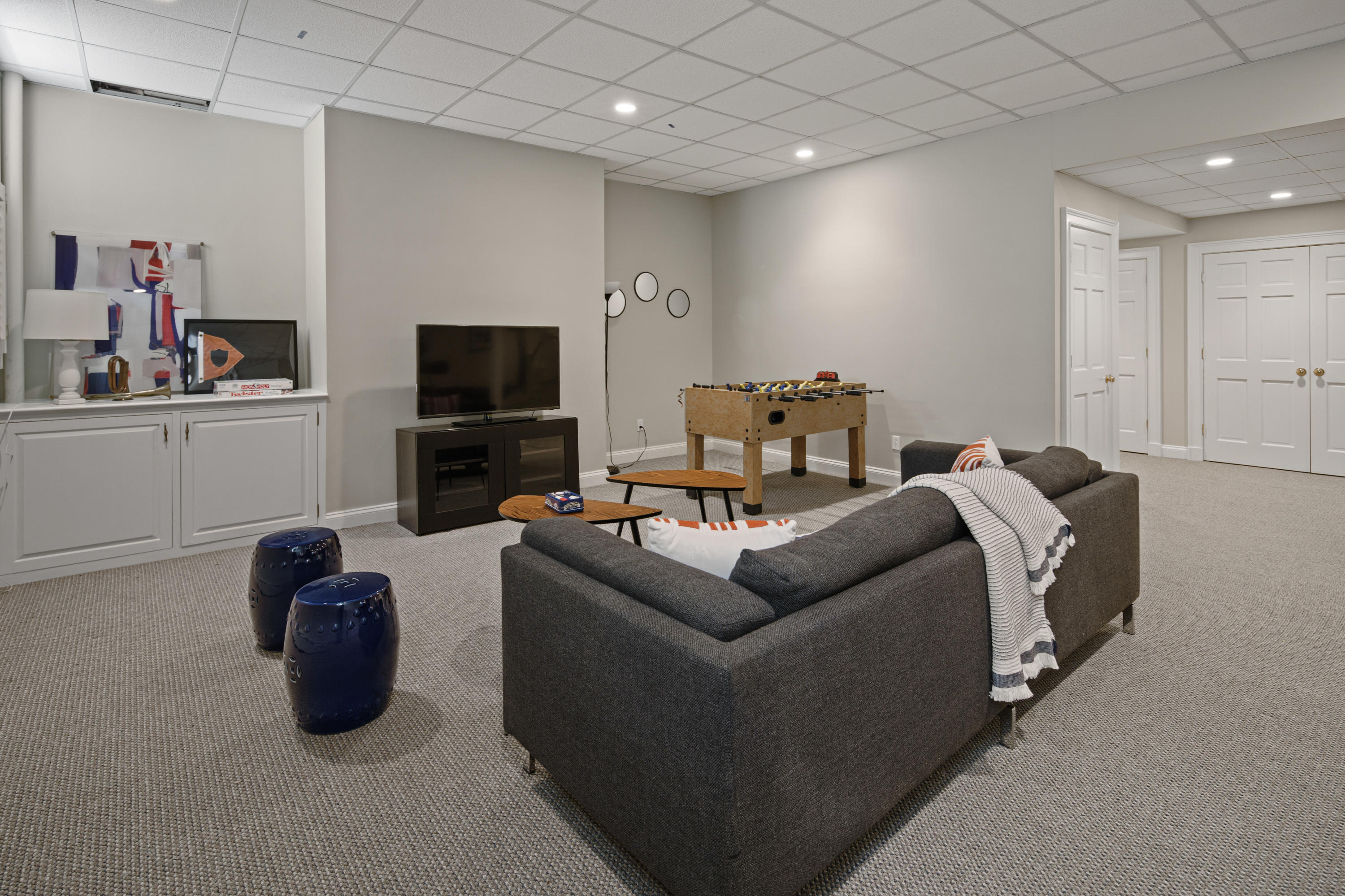 398 Valley Road New Canaan, CT 06840 - Photo 30 of 44 a living room with furniture a flat screen tv and kitchen view