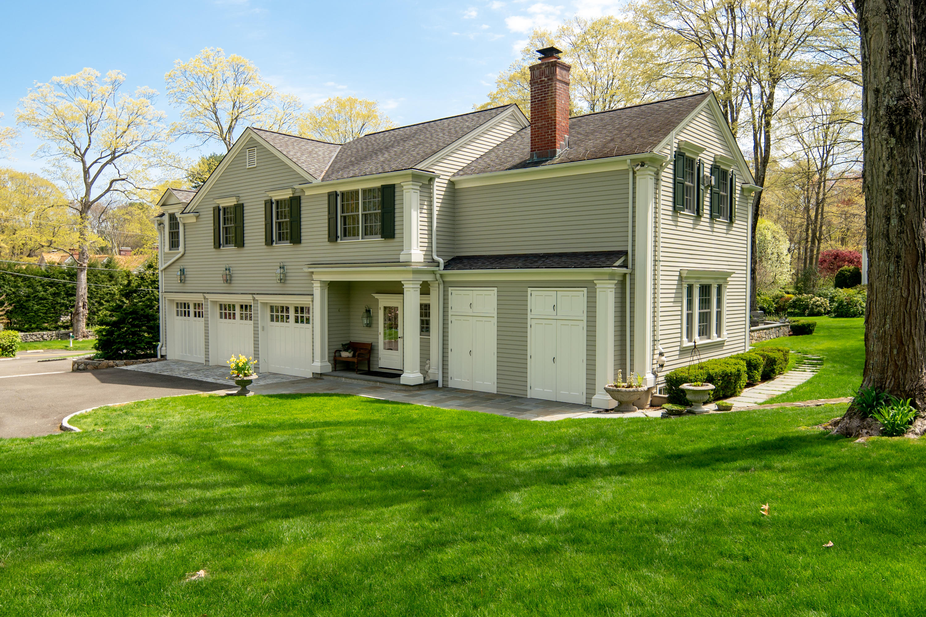 398 Valley Road New Canaan, CT 06840 - Photo 33 of 44 a front view of a house with a yard