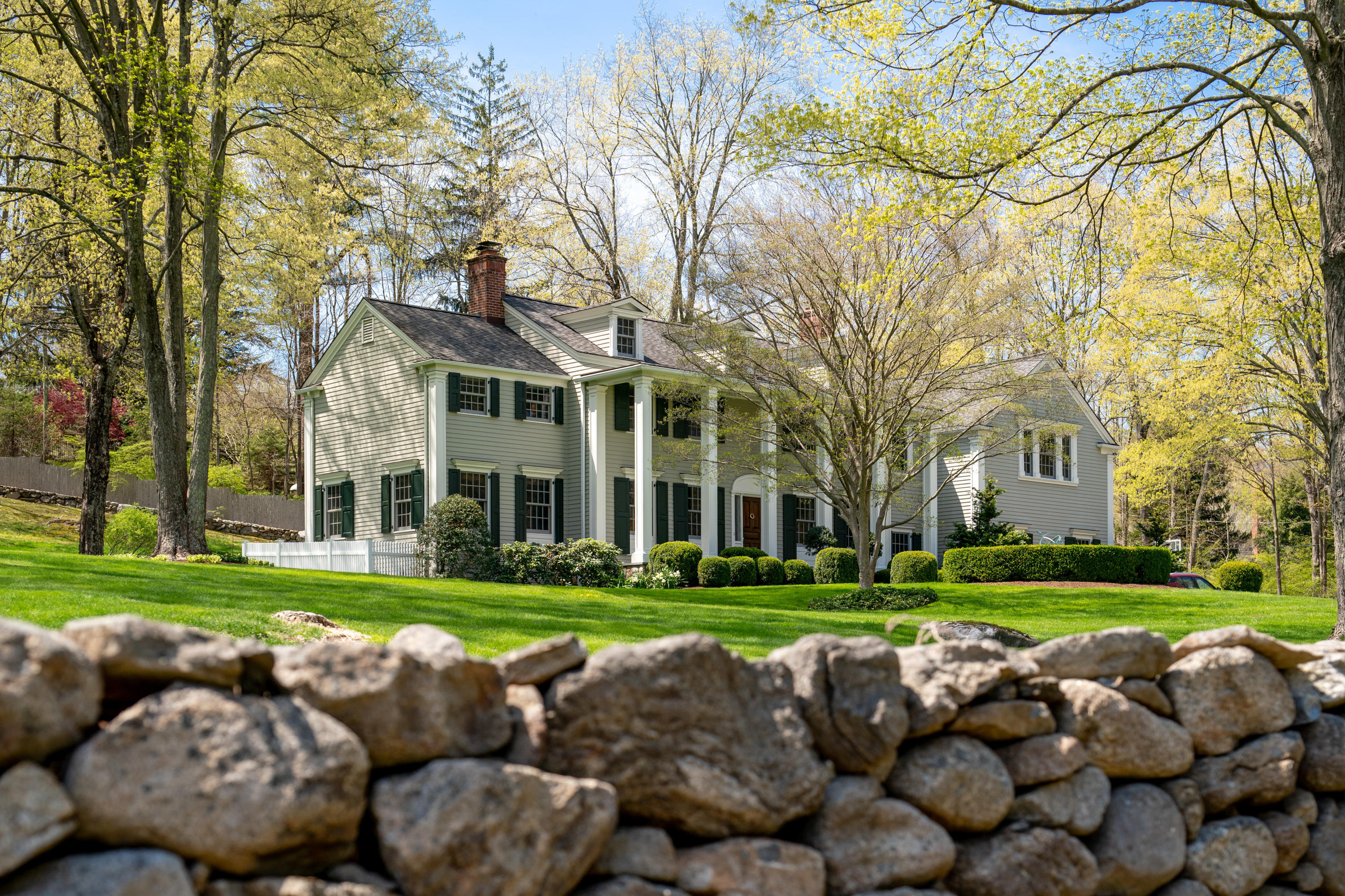 398 Valley Road New Canaan, CT 06840 - Photo 35 of 44 a view of a building with a yard