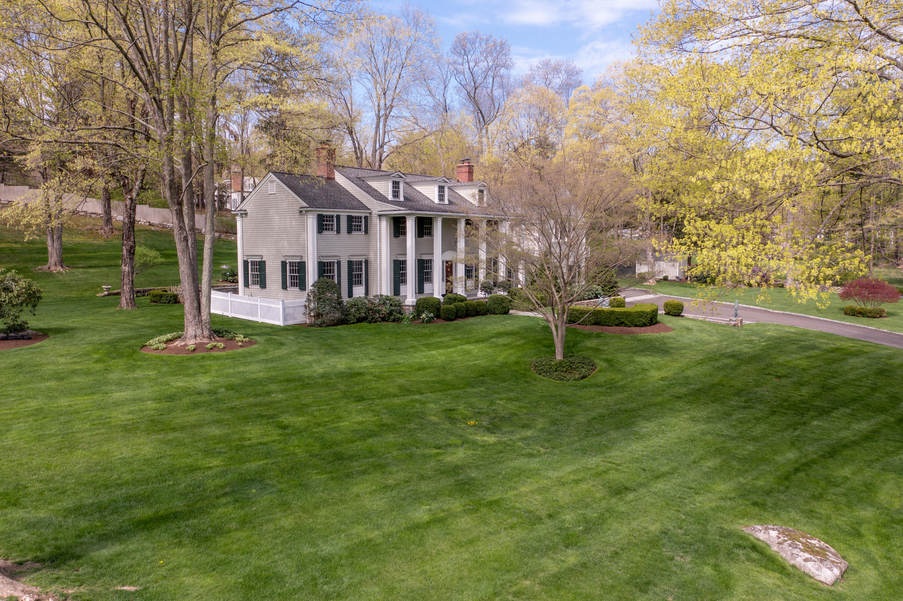 398 Valley Road New Canaan, CT 06840 - Photo 36 of 44 a view of a house with a yard