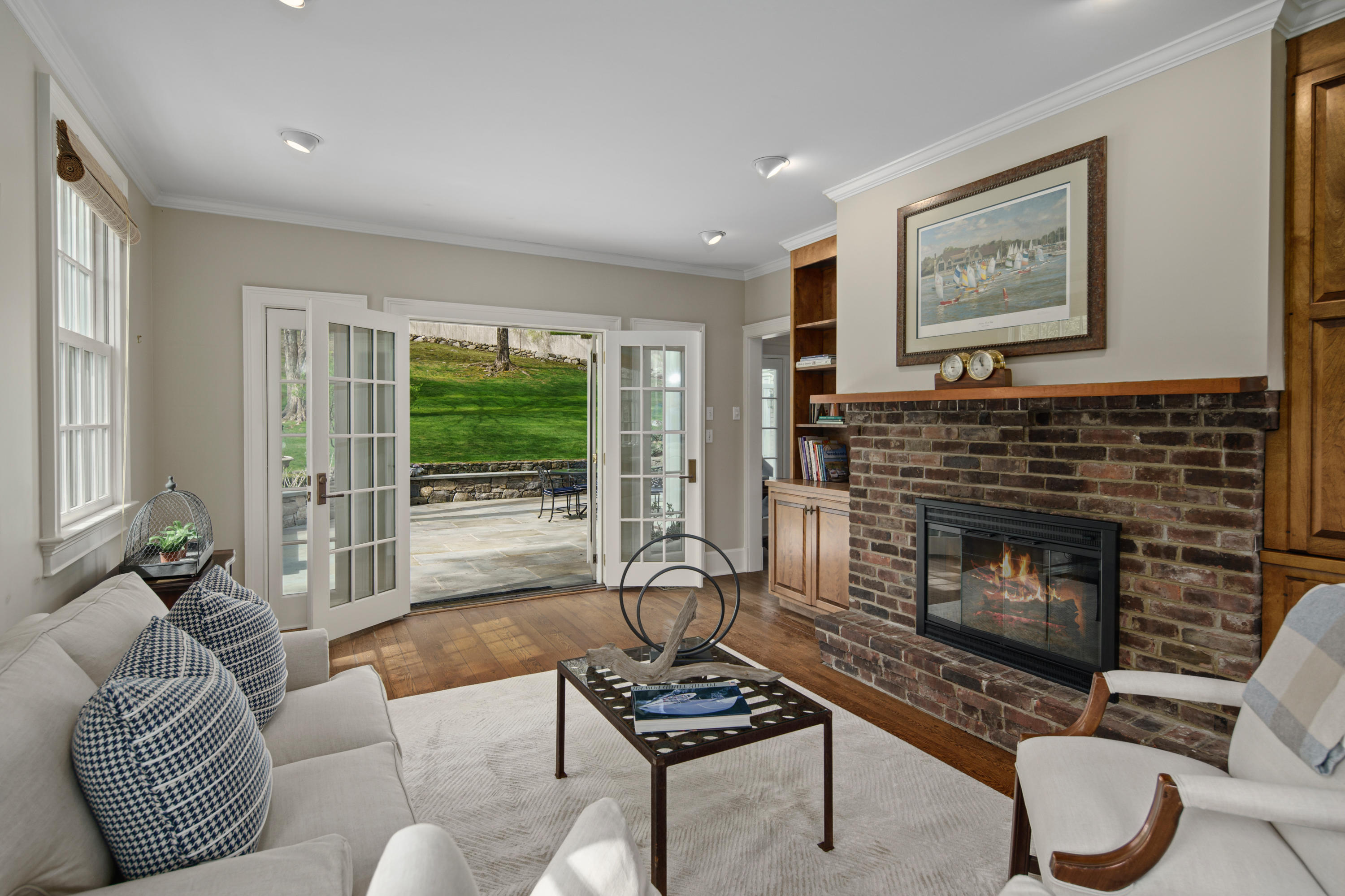 398 Valley Road New Canaan, CT 06840 - Photo 8 of 44 a living room with furniture a fireplace and a floor to ceiling window