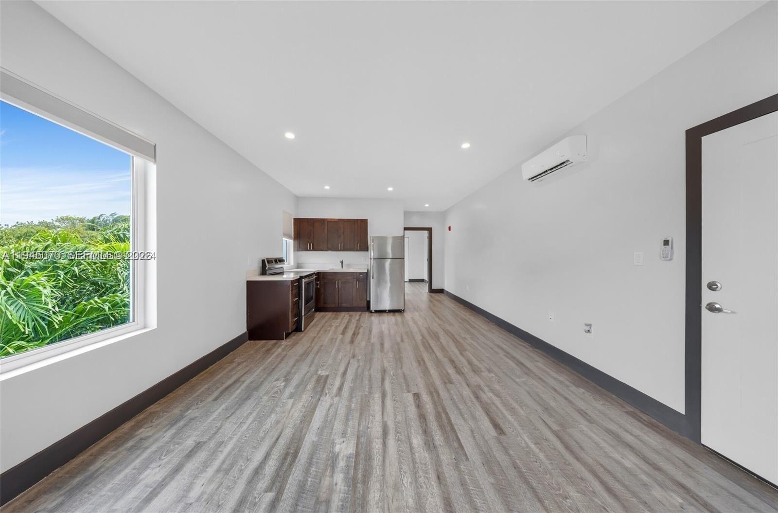 1020 Southwest 23rd Avenue, Unit 3 Miami, FL 33135 - Photo 3 of 15 a view of a kitchen with wooden floor electronic appliances and window