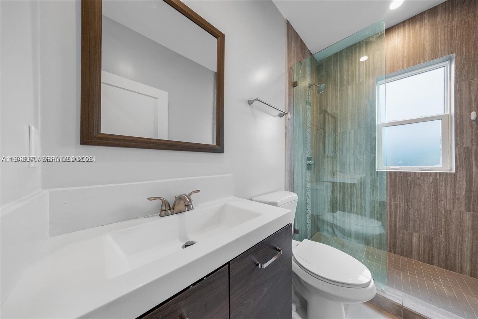 1020 Southwest 23rd Avenue, Unit 3 Miami, FL 33135 - Photo 9 of 15 a bathroom with a sink a toilet and shower