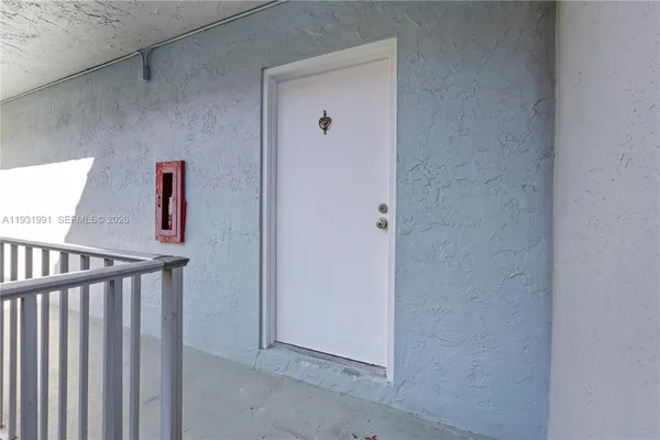 a view of a hallway with wooden floor and closet