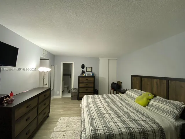a bedroom with a bed and a flat screen television