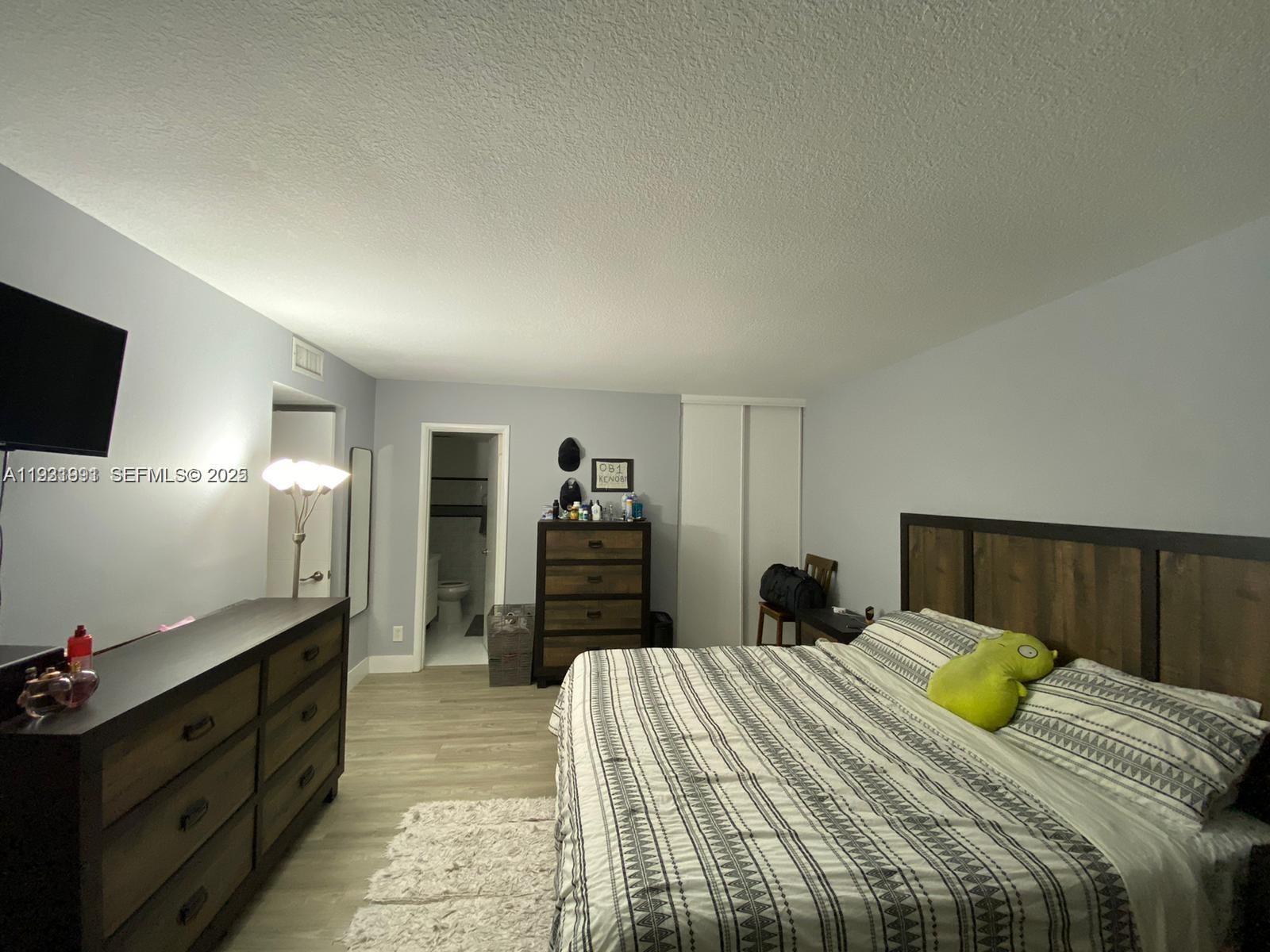 455 South Pine Island Road, Unit 307C Plantation, FL 33324 - Photo 13 of 17 a bedroom with a bed and a flat screen television