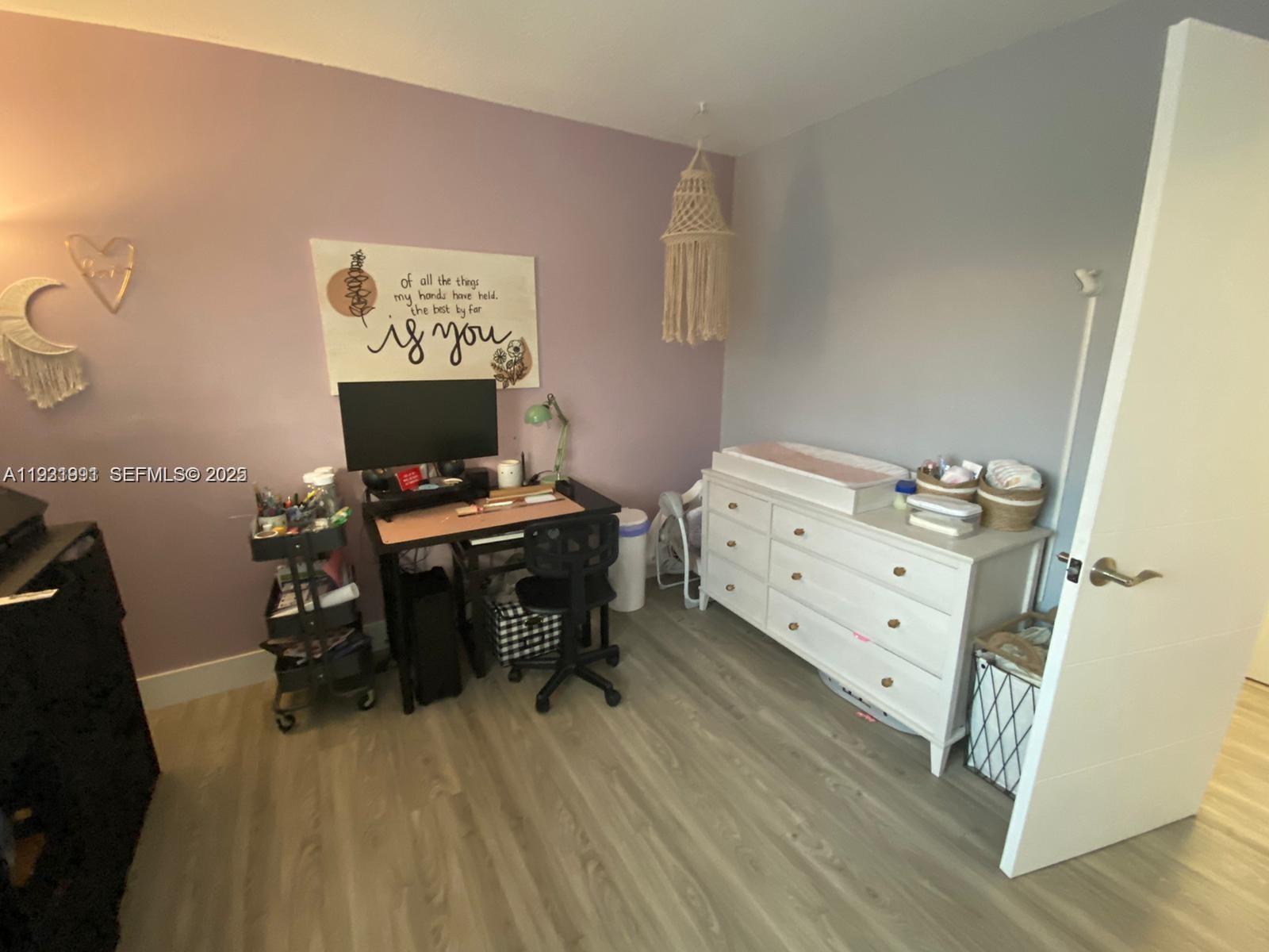 455 South Pine Island Road, Unit 307C Plantation, FL 33324 - Photo 16 of 17 a workspace with furniture and wooden floor