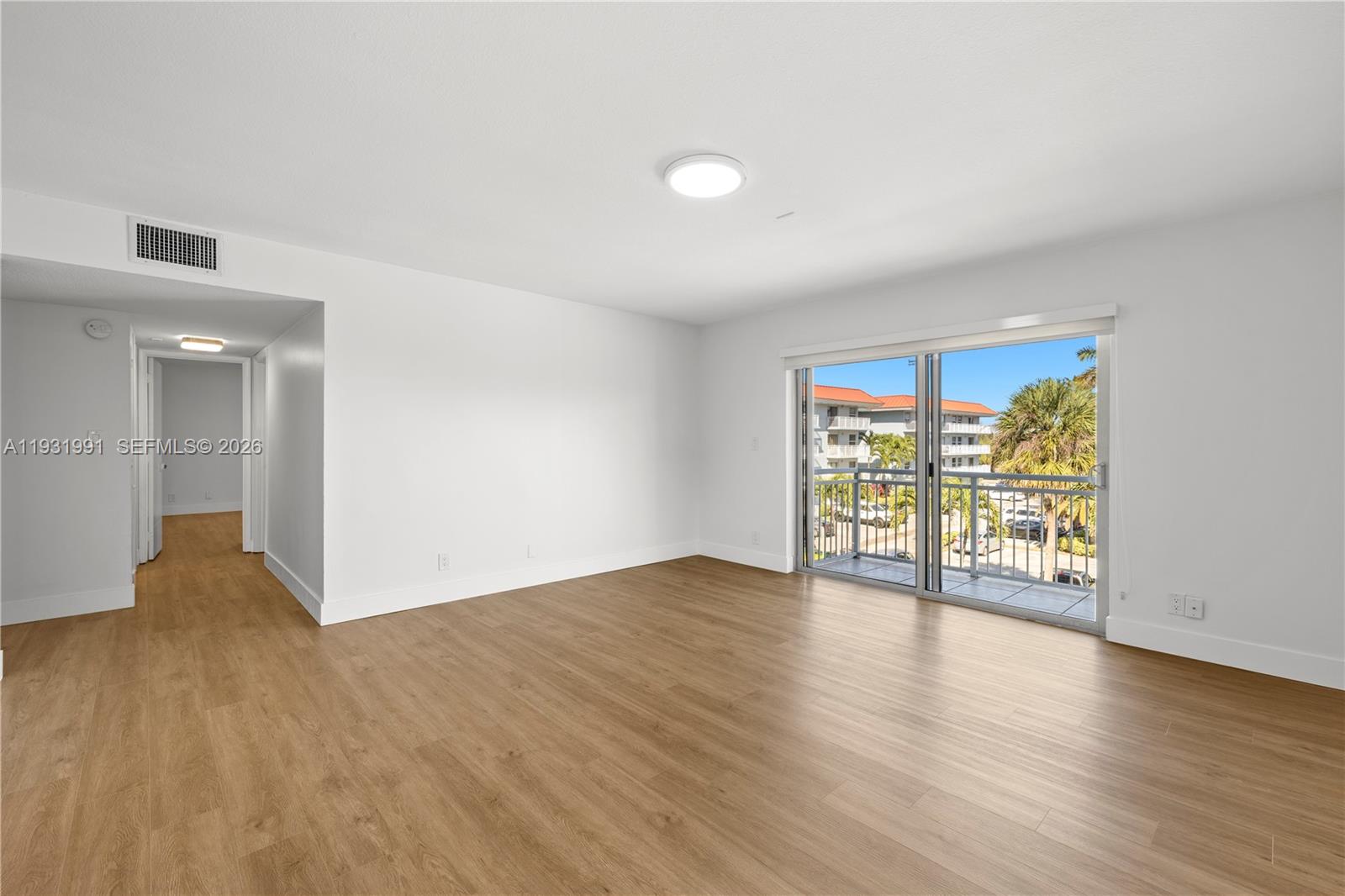 455 South Pine Island Road, Unit 307C Plantation, FL 33324 - Photo 18 of 30 a view of an empty room with wooden floor and a window