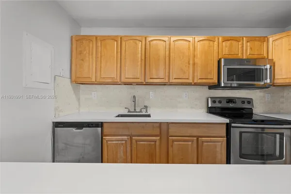 a kitchen with stainless steel appliances granite countertop a stove top oven microwave and cabinets