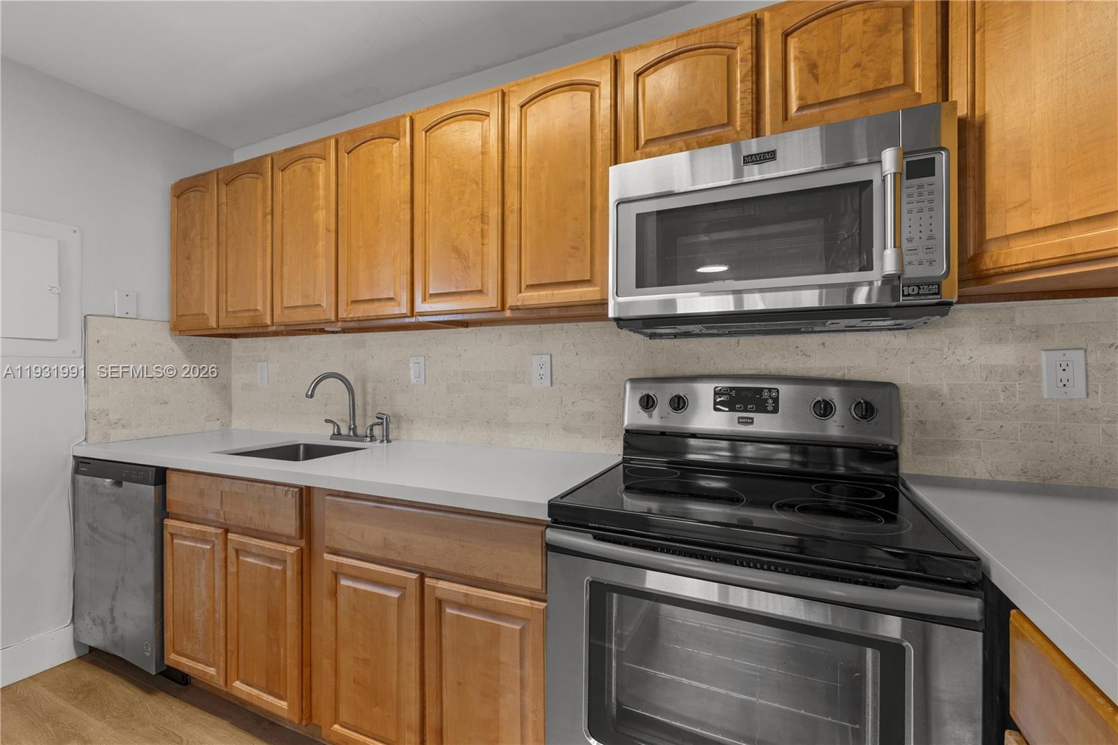 455 South Pine Island Road, Unit 307C Plantation, FL 33324 - Photo 20 of 30 a kitchen with stainless steel appliances granite countertop a stove microwave and sink