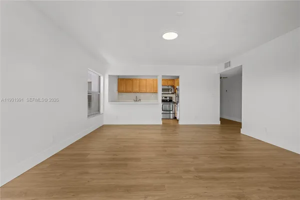 a view of an empty room with a window