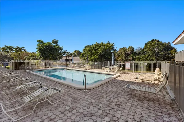 a view of a swimming pool with a lounge chair