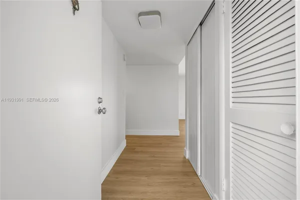 a view of a hallway with wooden floor