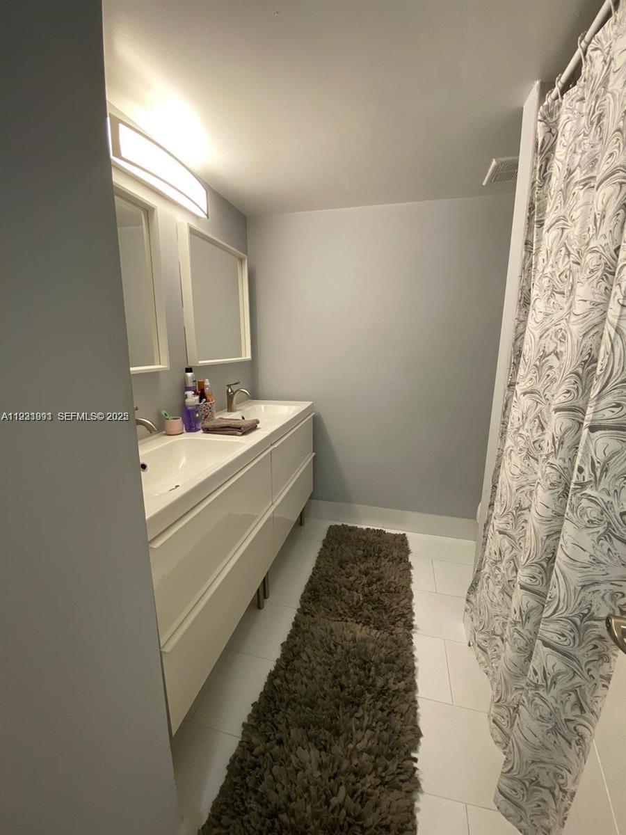 455 South Pine Island Road, Unit 307C Plantation, FL 33324 - Photo 4 of 17 a bathroom with a sink and a mirror