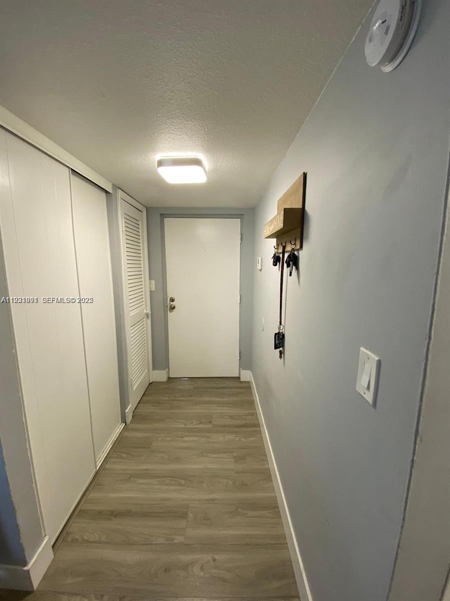 455 South Pine Island Road, Unit 307C Plantation, FL 33324 - Photo 5 of 17 a view of a hallway with wooden floor and cabinet