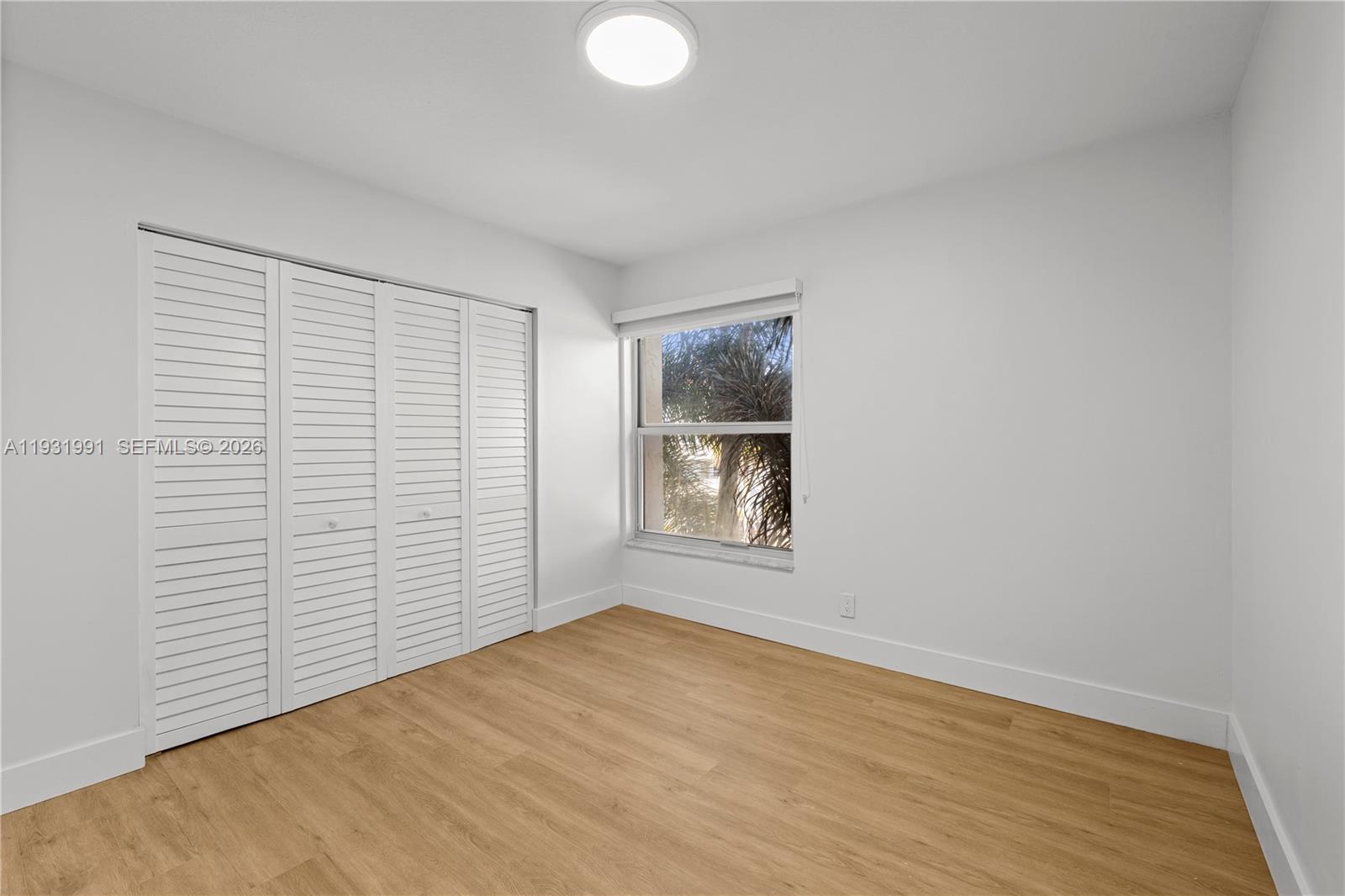 455 South Pine Island Road, Unit 307C Plantation, FL 33324 - Photo 9 of 30 a view of empty room with wooden floor and fan