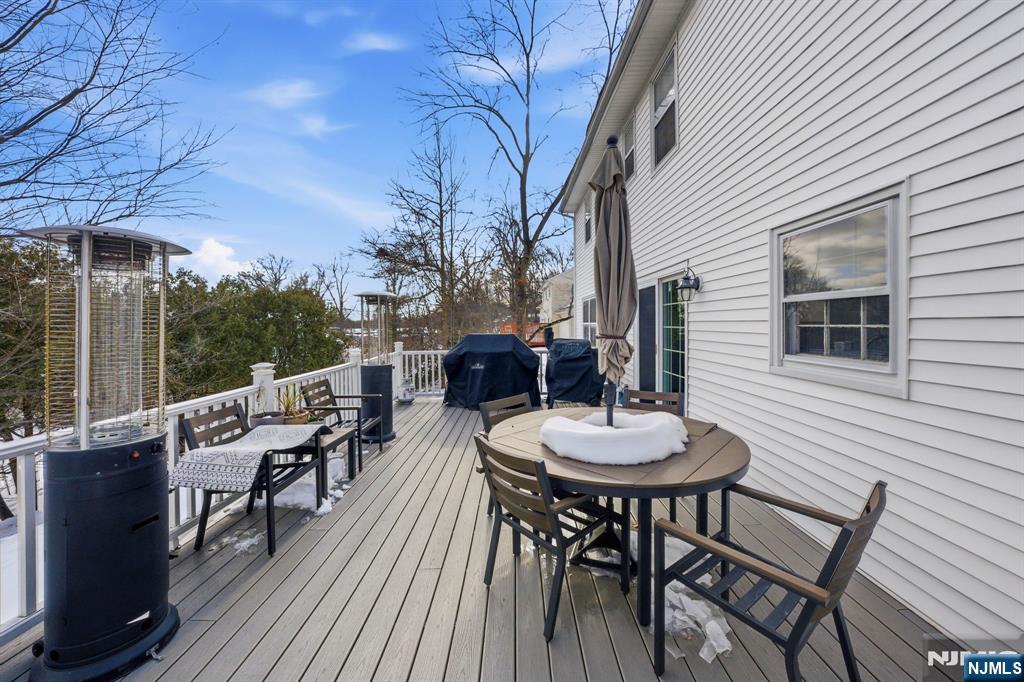 18 Laura Lane Park Ridge, NJ 07656 - Photo 20 of 36 a balcony view with a dining table and chairs with wooden floor and fence