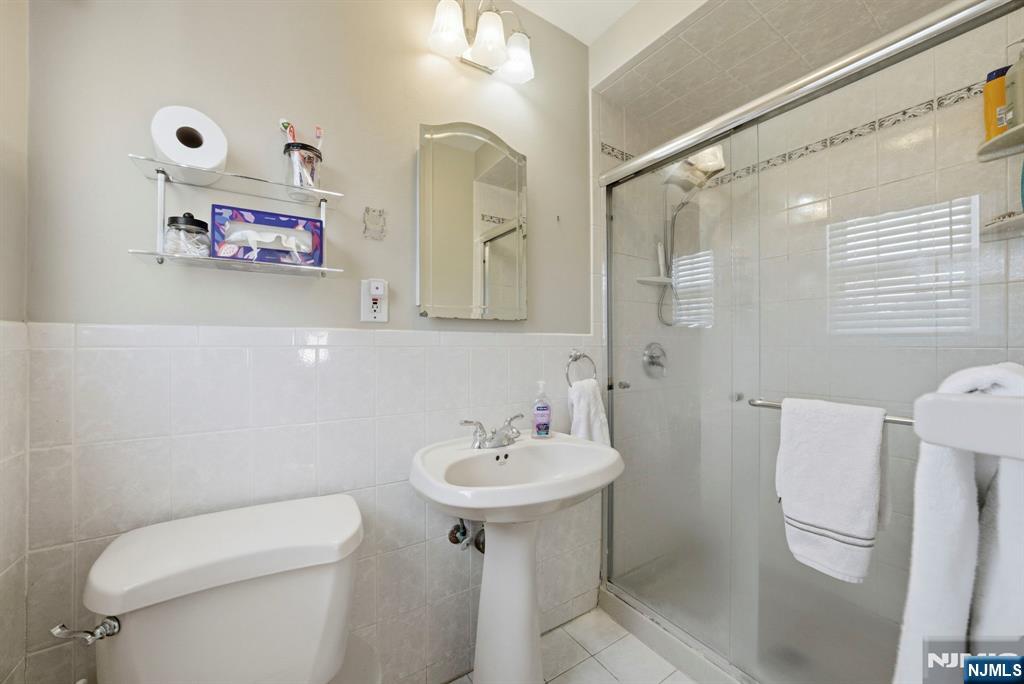 18 Laura Lane Park Ridge, NJ 07656 - Photo 25 of 36 a bathroom with a sink mirror toilet and vanity