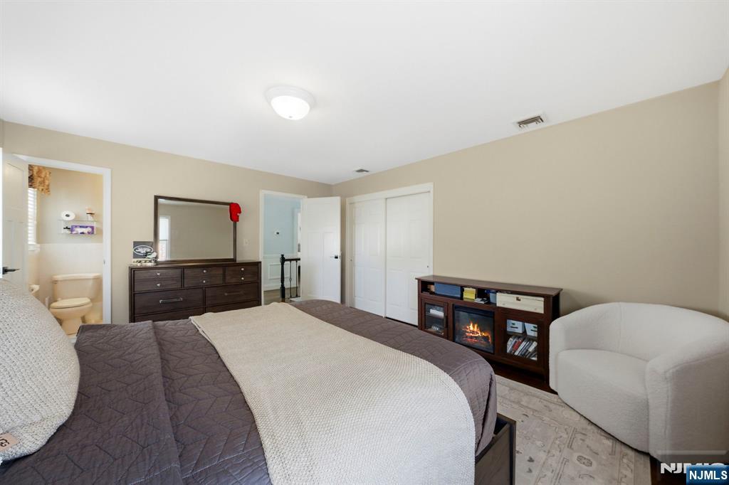 18 Laura Lane Park Ridge, NJ 07656 - Photo 26 of 36 a large bedroom with a bed and a flat screen tv