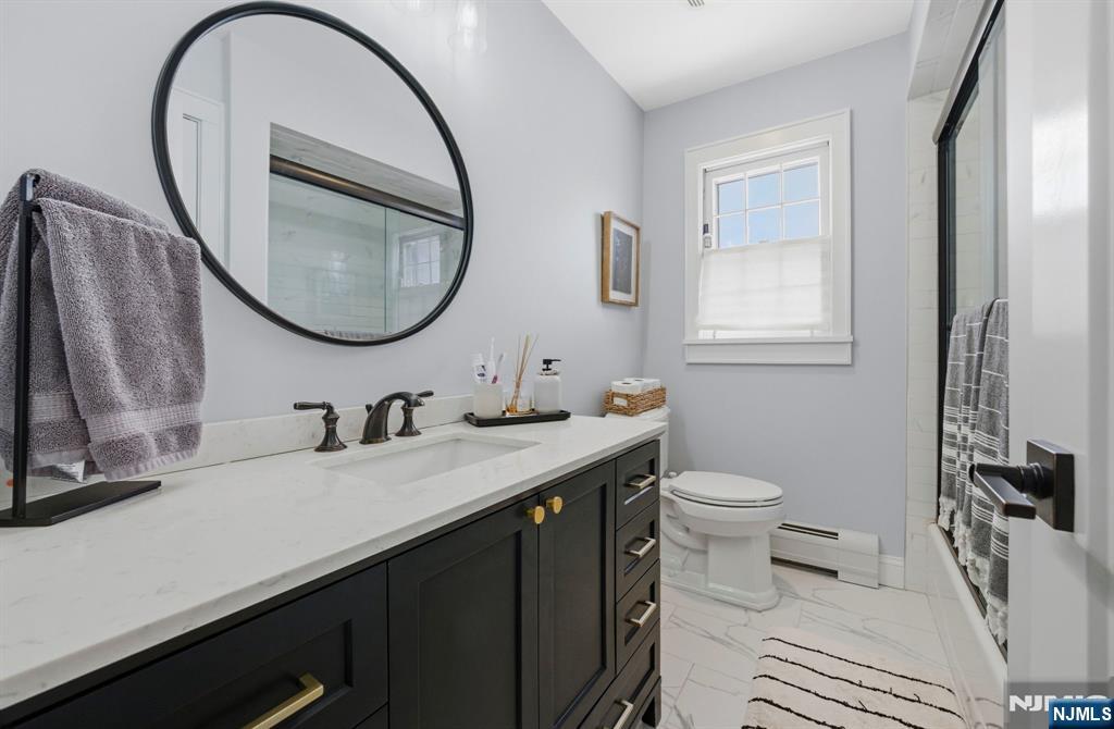 18 Laura Lane Park Ridge, NJ 07656 - Photo 27 of 36 a bathroom with a sink a toilet and a mirror