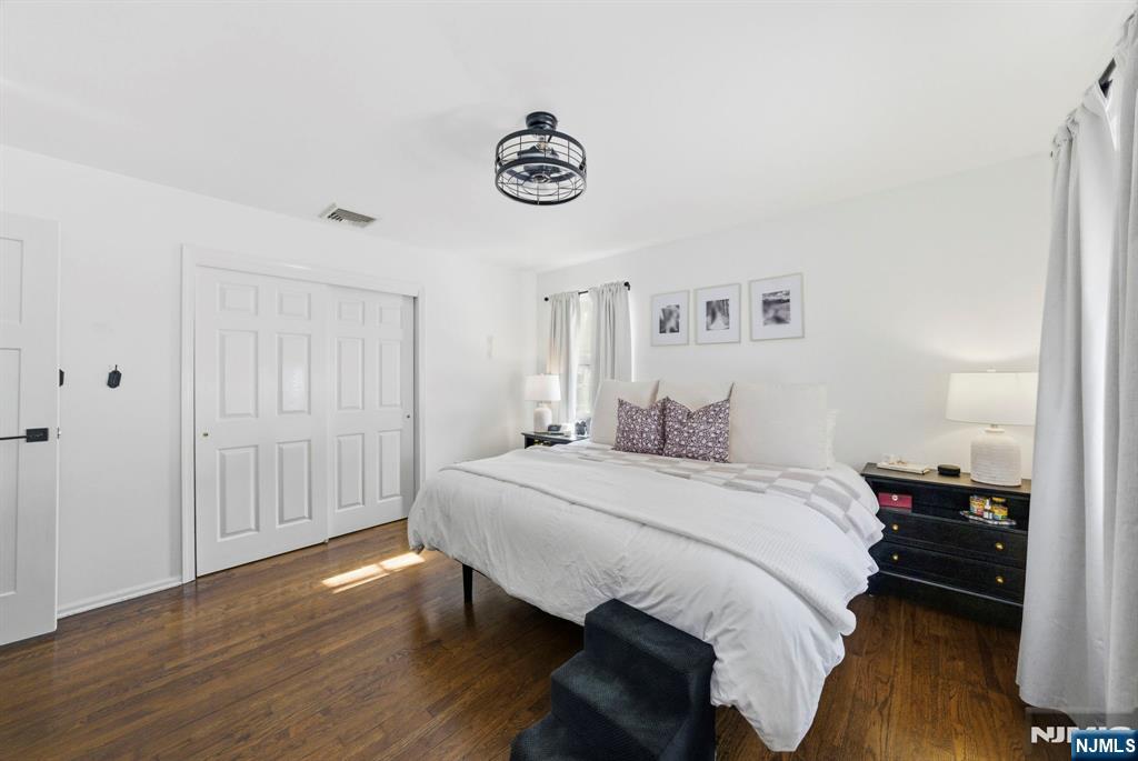 18 Laura Lane Park Ridge, NJ 07656 - Photo 31 of 36 a spacious bedroom with a bed and a table in it