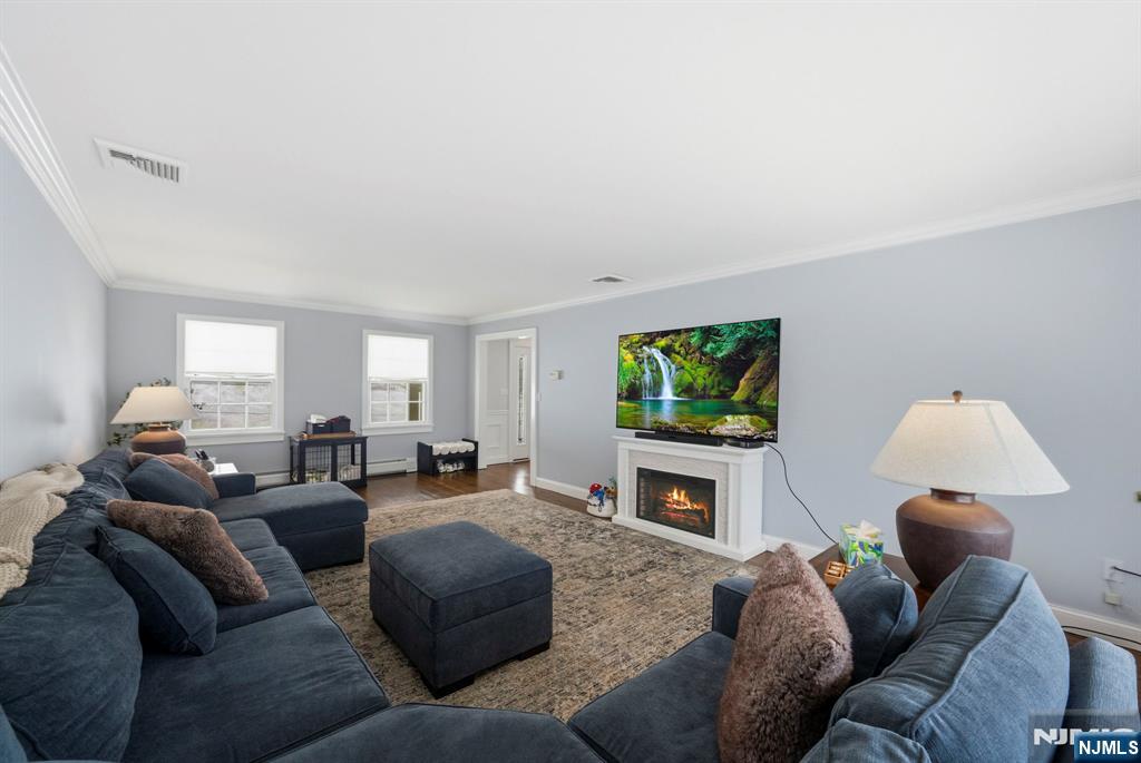 18 Laura Lane Park Ridge, NJ 07656 - Photo 8 of 36 a living room with furniture a fireplace and a flat screen tv