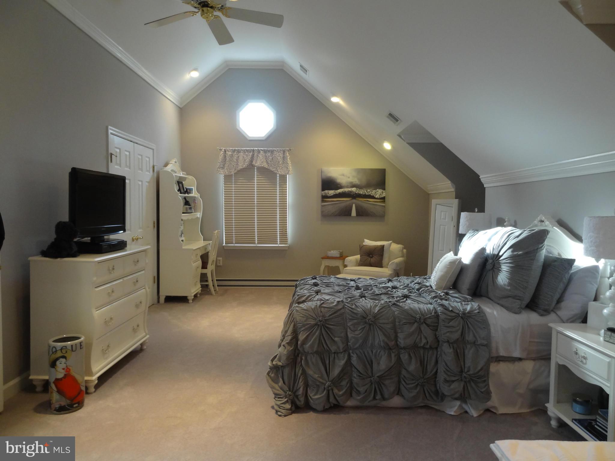 491 Ferry Point Road Annapolis, MD 21403 - Photo 11 of 30 a spacious bedroom with a bed and a flat tv screen on wall
