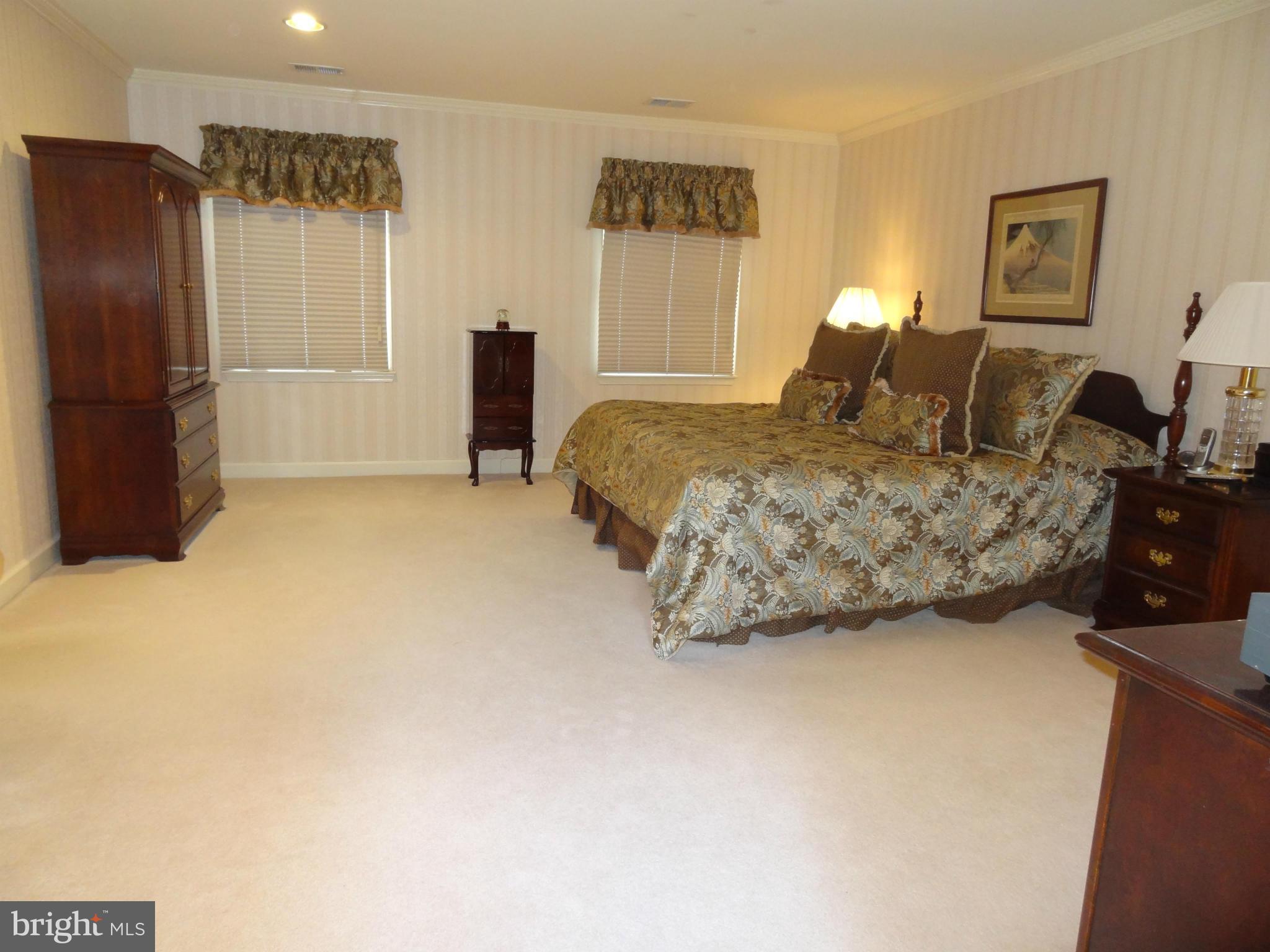 491 Ferry Point Road Annapolis, MD 21403 - Photo 7 of 30 a bedroom with a bed and a refrigerator