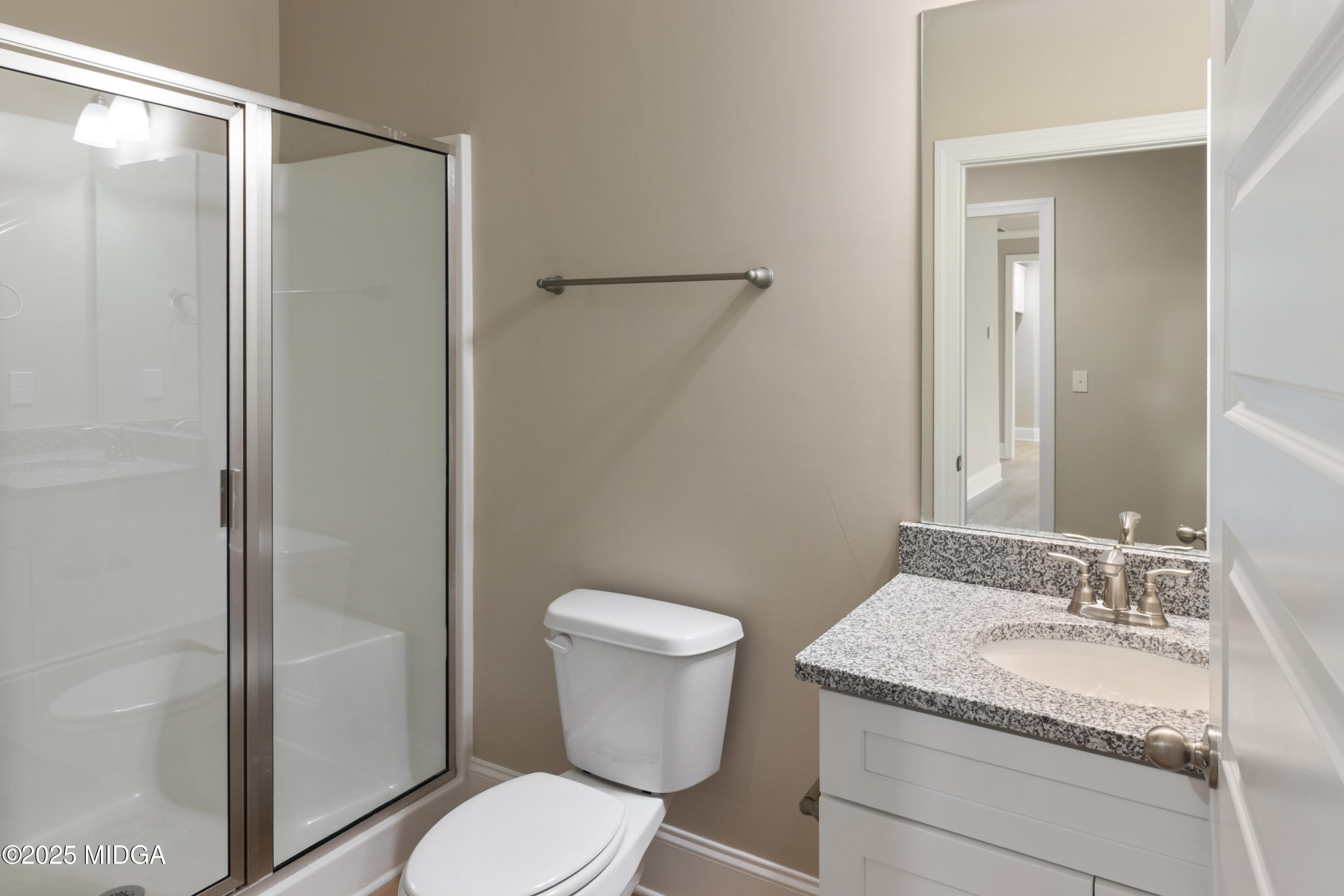 703 Giles Road Forsyth, GA 31029 - Photo 16 of 30 a bathroom with a granite countertop sink toilet and shower